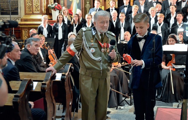 Leszek Włodek, żołnierz Szarych Szeregów i Armii Krajowej, z dumą przekazuje
Aleksandrowi Zarębińskiemu biało-czerwoną opaskę Armii Krajowej
