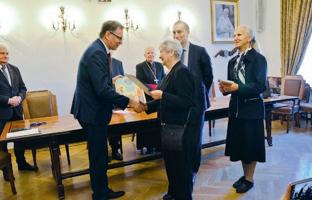 Ikonę Świętej Rodziny wręczają laureatowi przedstawiciele Kapituły Nagrody